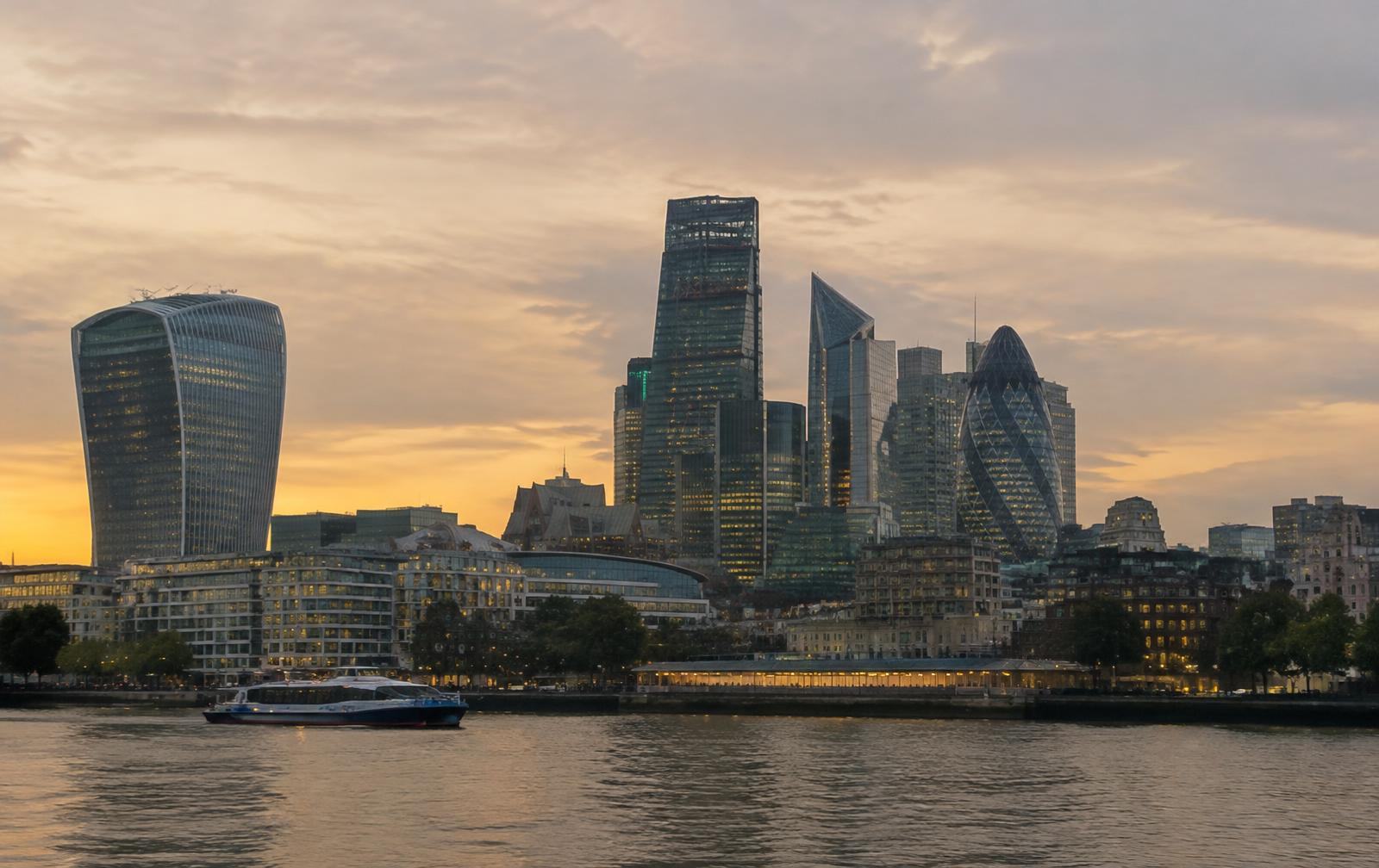 The City of London skyline at dusk seen across the River Thames